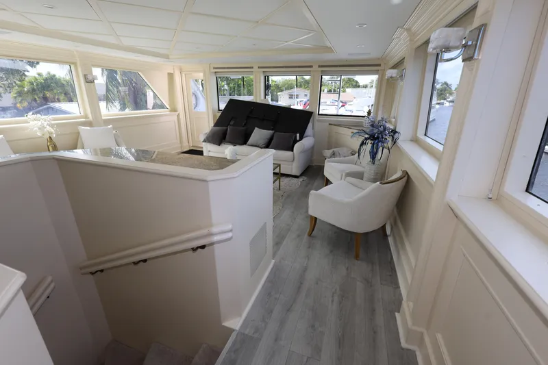 Slide: The Image of Luxurious interior of 1988 Broward 124 Tri-Deck MY yacht with elegant seating and large windows. - 21