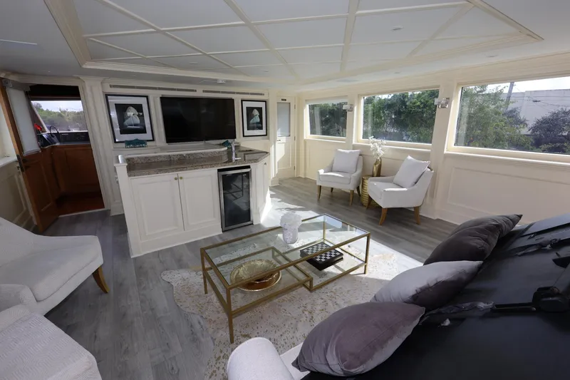 Slide: The Image of Luxurious interior of 1988 Broward 124 Tri-Deck MY yacht with elegant seating and modern decor. - 22