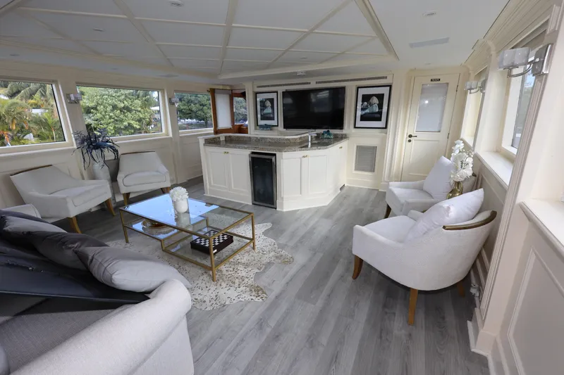 Slide: The Image of Luxurious interior of 1988 Broward 124 Tri-Deck MY yacht with elegant seating and modern decor. - 23