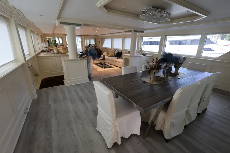Slide: The Image of Luxurious interior of 1988 Broward 124 Tri-Deck MY yacht with elegant dining area. - 24