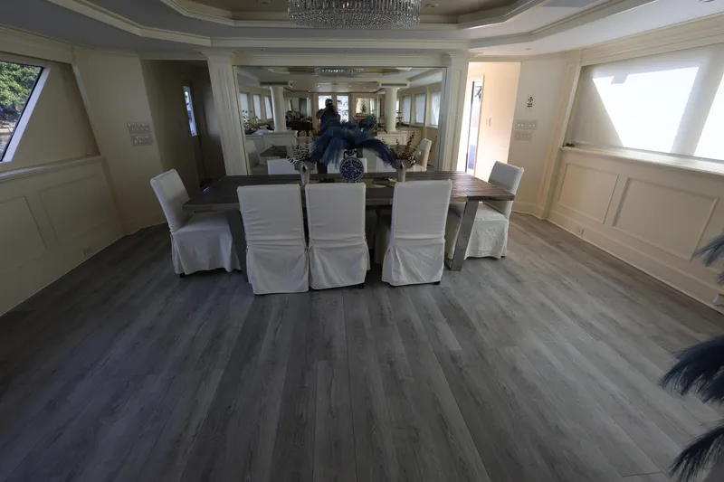 Slide: The Image of Luxurious dining area on 1988 Broward 124 Tri-Deck MY yacht with elegant decor. - 30