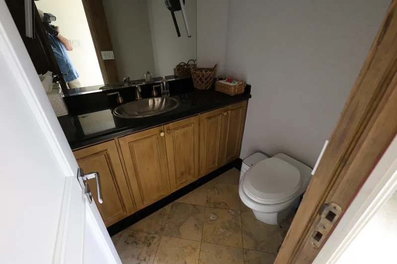 Slide: The Image of Bathroom interior of 1988 Broward 124 Tri-Deck MY yacht with sink and toilet. - 31