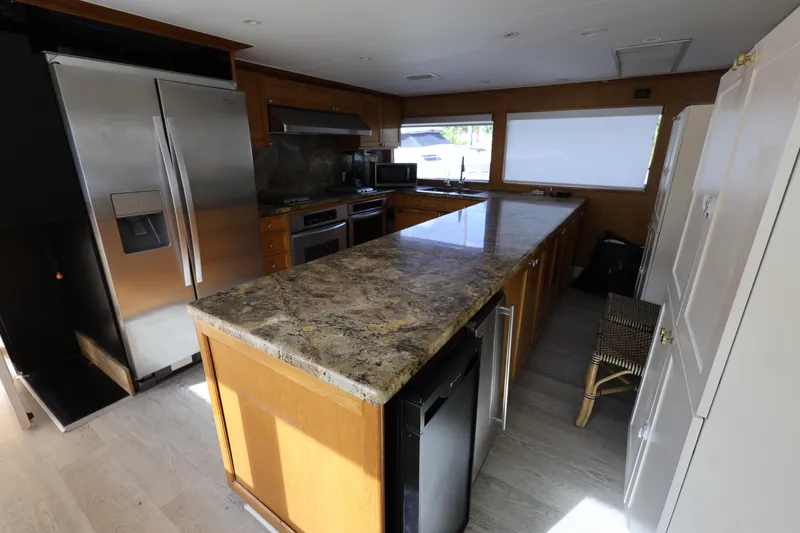 Slide: The Image of Luxurious kitchen interior on 1988 Broward 124 Tri-Deck MY yacht with modern appliances. - 32