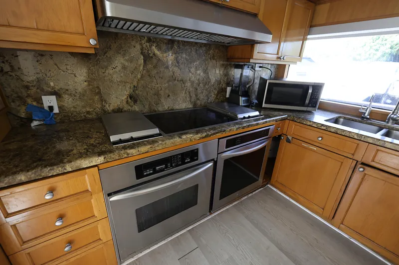 Slide: The Image of Kitchen interior of 1988 Broward 124 Tri-Deck MY yacht with modern appliances. - 33