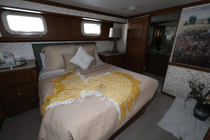 Slide: The Image of Luxurious bedroom in 1988 Broward 124 Tri-Deck MY yacht with elegant decor. - 38