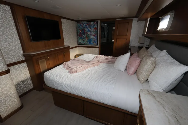 Slide: The Image of Luxurious bedroom interior of 1988 Broward 124 Tri-Deck MY yacht with cozy bedding. - 41