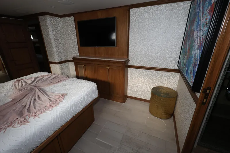 Slide: The Image of Bedroom interior of 1988 Broward 124 Tri-Deck MY yacht with TV and artwork. - 42