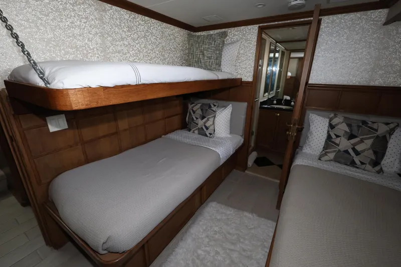 Slide: The Image of Luxurious cabin interior of 1988 Broward 124 Tri-Deck MY yacht with bunk beds. - 44