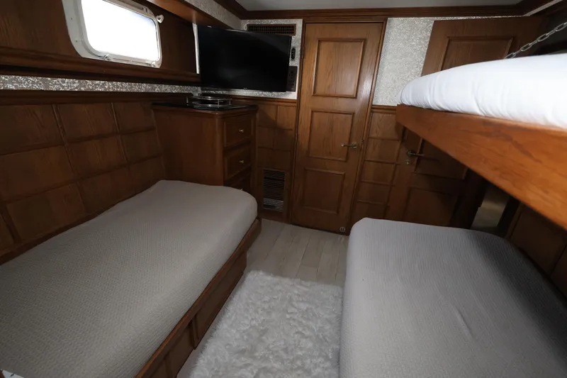 Slide: The Image of Luxurious cabin interior of 1988 Broward 124 Tri-Deck MY yacht with wooden furnishings. - 45