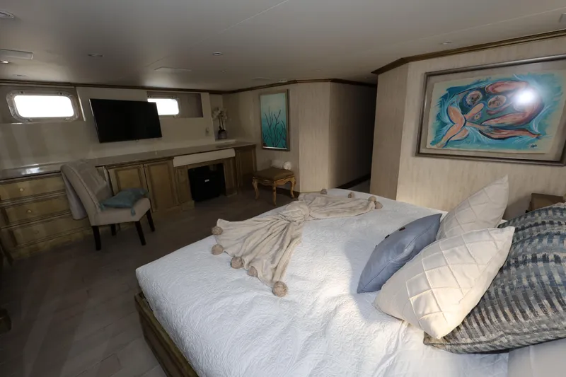 Slide: The Image of Luxurious bedroom interior on 1988 Broward 124 Tri-Deck MY yacht with modern decor. - 49