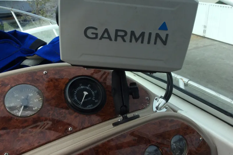 Slide: The Image of Garmin GPS on 2000 Maxum 2800 SCR boat dashboard with wood paneling. - 11