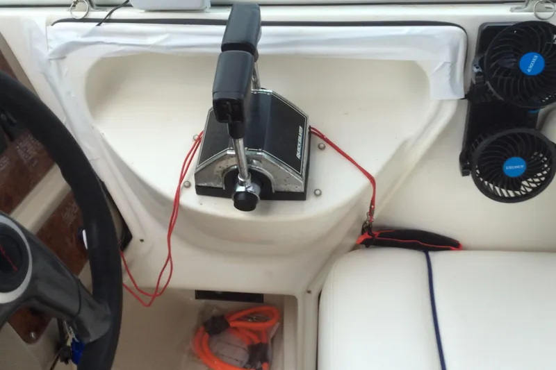 Slide: The Image of Control panel of a 2000 Maxum 2800 SCR boat with throttle and fans. - 13