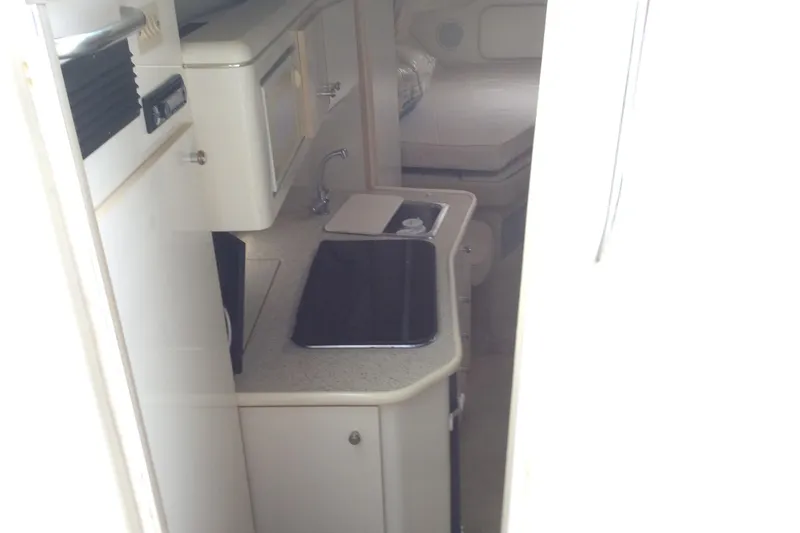 Slide: The Image of 2000 Maxum 2800 SCR boat interior with kitchenette and sleeping area. - 14