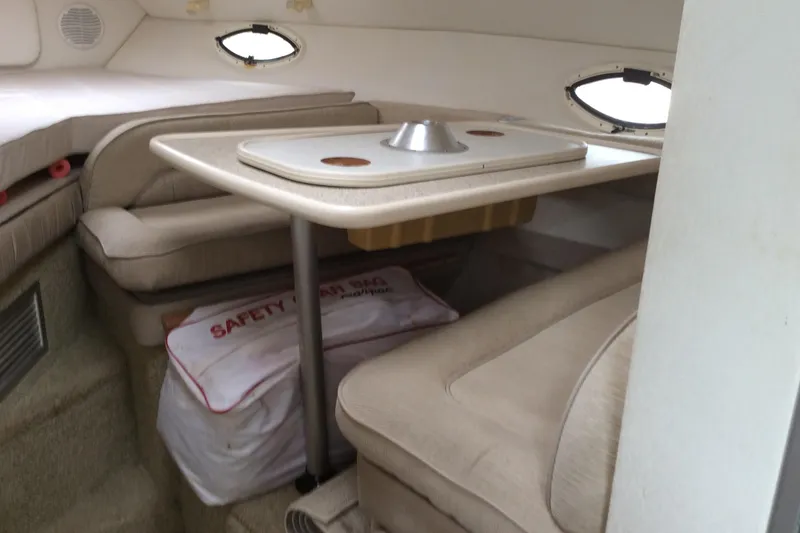 Slide: The Image of 2000 Maxum 2800 SCR cabin interior with table and seating area. - 16