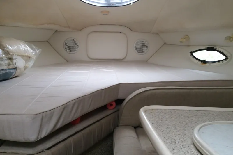 Slide: The Image of Interior cabin of 2000 Maxum 2800 SCR boat with bed and seating area. - 17