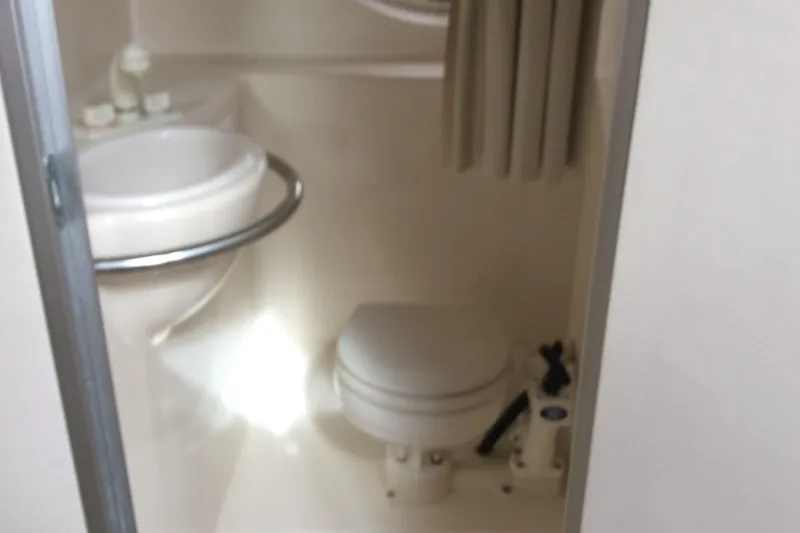 Slide: The Image of Compact bathroom in 2000 Maxum 2800 SCR boat with sink and toilet. - 18
