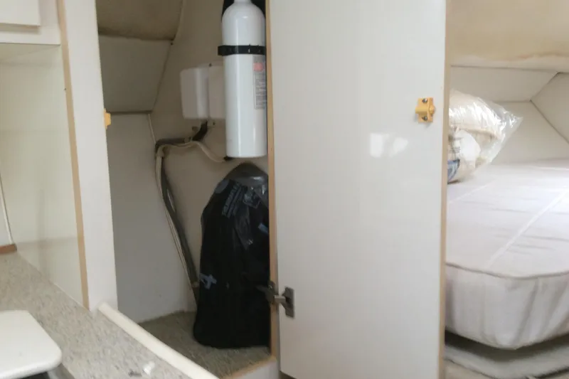 Slide: The Image of Interior of 2000 Maxum 2800 SCR boat showing storage area and bed. - 26