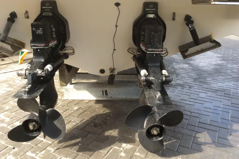 Slide: The Image of Maxum 2800 SCR 2000 boat with dual propellers on a paved surface. - 4