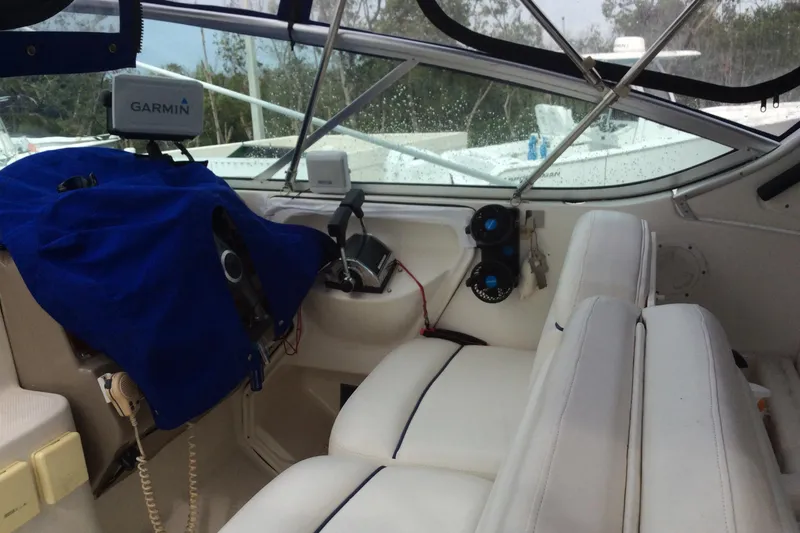 Slide: The Image of Interior of 2000 Maxum 2800 SCR boat with white seating and navigation equipment. - 7