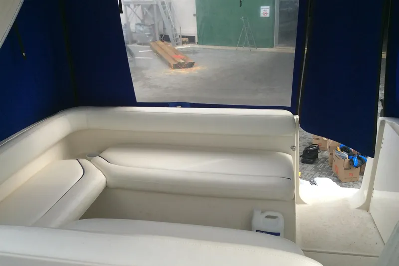 Slide: The Image of Interior seating of 2000 Maxum 2800 SCR boat with blue curtains. - 9