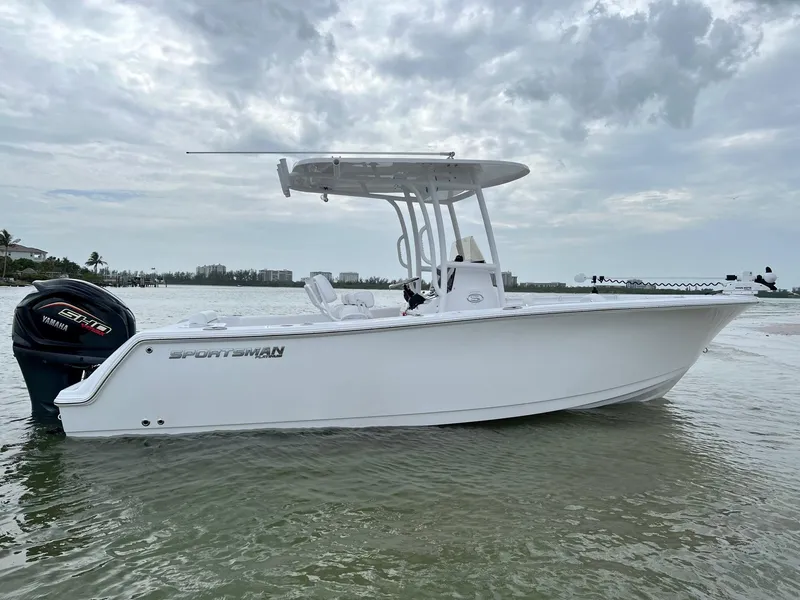 Slide: The Image of 2023 Sportsman Open 232 Center Console boat on calm water under cloudy sky. - 0