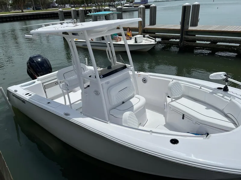Slide: The Image of 2023 Sportsman Open 232 Center Console boat docked in marina. - 2