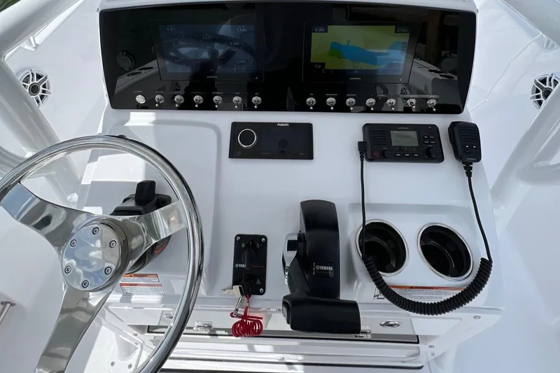 Slide: The Image of 2023 Sportsman Open 232 Center Console dashboard with steering wheel and navigation controls. - 4