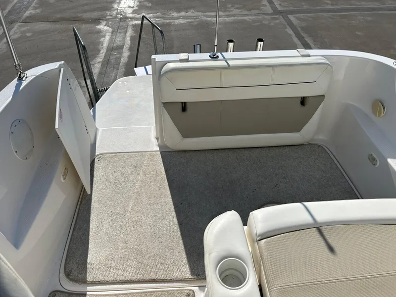 Slide: The Image of 2013 Bayliner 245 Cruiser boat interior with seating and storage area. - 10