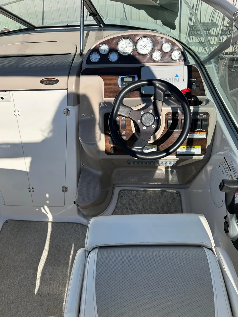 Slide: The Image of 2013 Bayliner 245 Cruiser dashboard with steering wheel and instrument panel. - 3