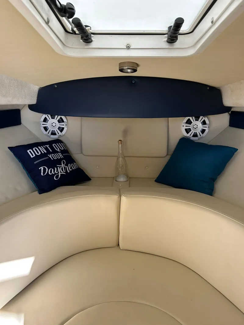 Slide: The Image of Interior of 2013 Bayliner 245 Cruiser with cozy seating and decorative pillows. - 5
