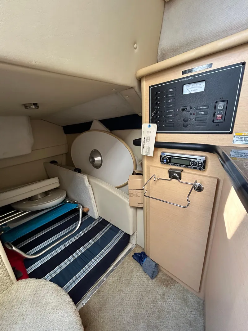 Slide: The Image of Interior cabin of 2013 Bayliner 245 Cruiser with control panel and seating area. - 8