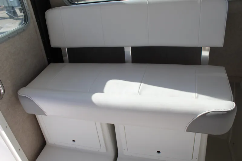 Slide: The Image of Interior seating of 2025 Parker 2520 boat, featuring white cushioned bench. - 3