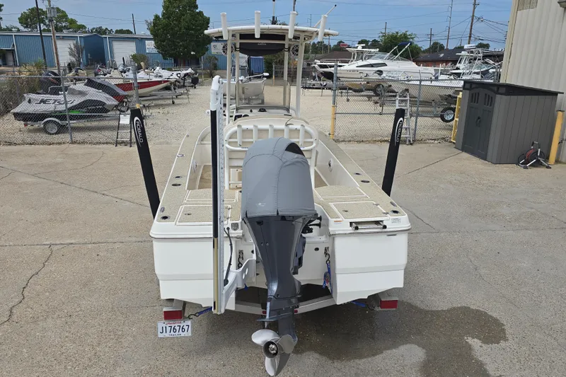 Slide: The Image of 2017 Robalo 206 Cayman boat with outboard motor in a marina setting. - 10
