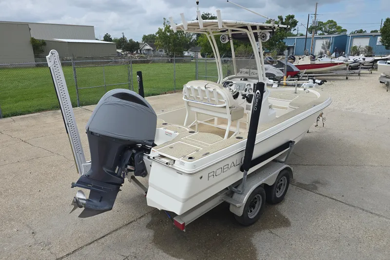 Slide: The Image of 2017 Robalo 206 Cayman boat on trailer, featuring outboard motor and T-top. - 11