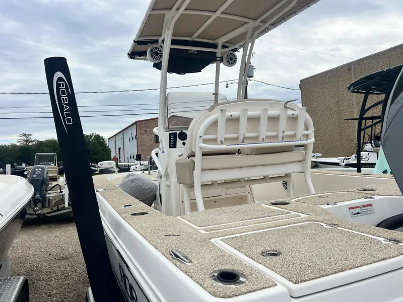 Slide: The Image of 2017 Robalo 206 Cayman boat on trailer, parked outside industrial building. - 2