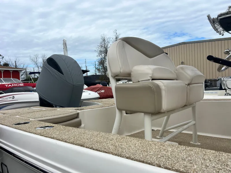 Slide: The Image of 2017 Robalo 206 Cayman boat with beige seating, outdoor storage setting. - 6