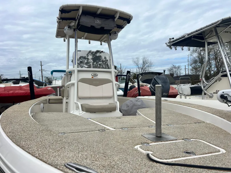 Slide: The Image of 2017 Robalo 206 Cayman boat with T-top, docked outdoors. - 7