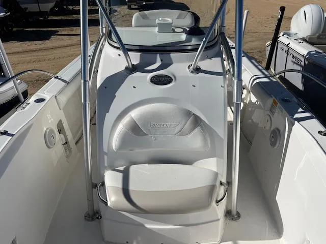 Slide: The Image of 2004 Boston Whaler 240 Outrage boat interior with seating and console. - 12
