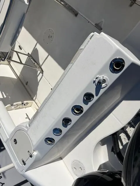 Slide: The Image of Boston Whaler 240 Outrage 2004 boat interior with rod holders and storage. - 2