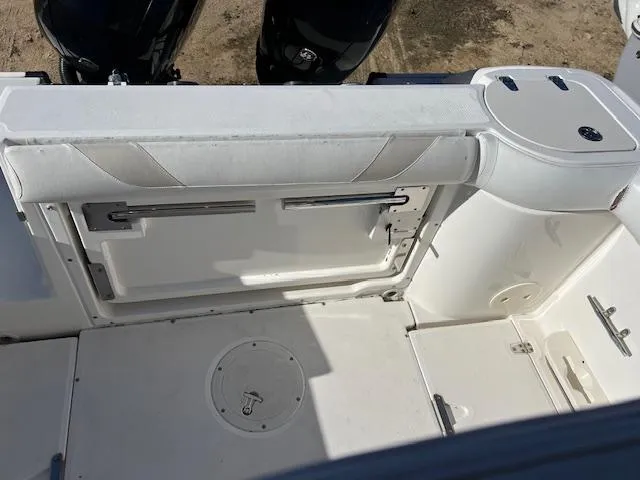 Slide: The Image of Boston Whaler 240 Outrage 2004 boat interior with seating and storage compartments. - 3