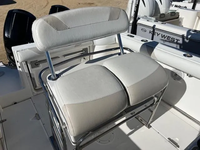 Slide: The Image of Boston Whaler 240 Outrage 2004 boat seating with white cushioned bench and backrest. - 4