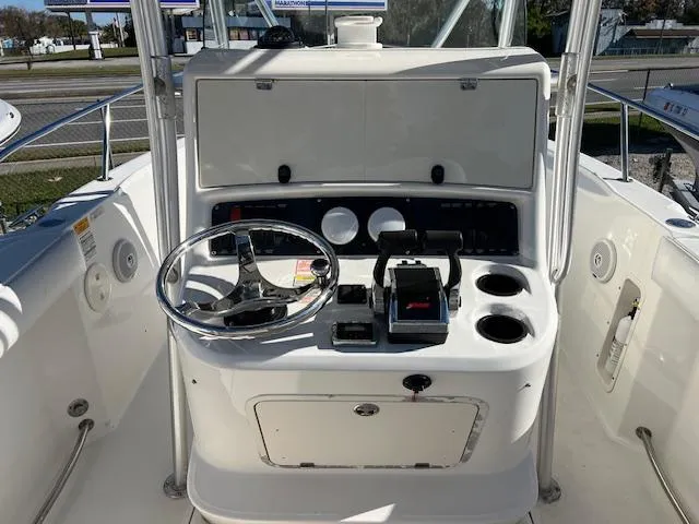Slide: The Image of Boston Whaler 240 Outrage 2004 boat console with steering wheel and controls. - 5