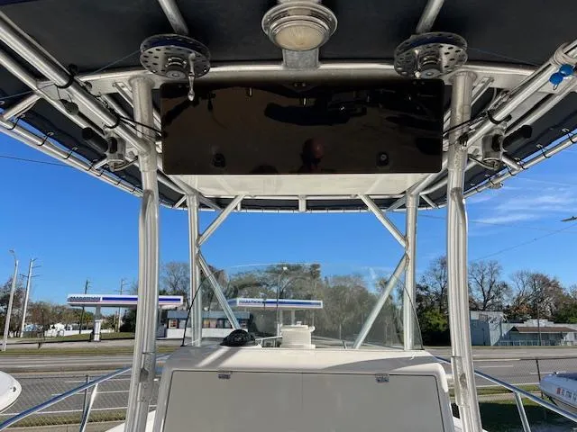 Slide: The Image of Boston Whaler 240 Outrage 2004 boat console with T-top and clear sky background. - 6
