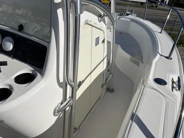 Slide: The Image of 2004 Boston Whaler 240 Outrage boat interior with console and seating area. - 8