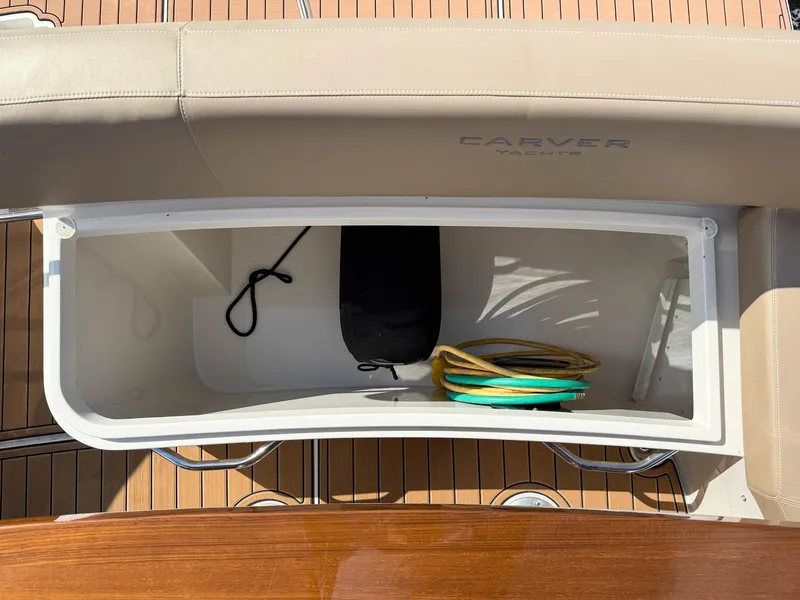 Slide: The Image of Storage compartment on 2016 Carver C37 Coupe yacht with coiled rope and black bag. - 24