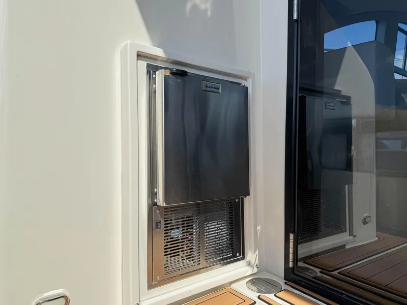 Slide: The Image of Built-in stainless steel refrigerator on 2016 Carver C37 Coupe yacht deck. - 27