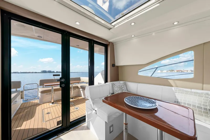 Slide: The Image of Interior of 2016 Carver C37 Coupe yacht with elegant seating and ocean view. - 30