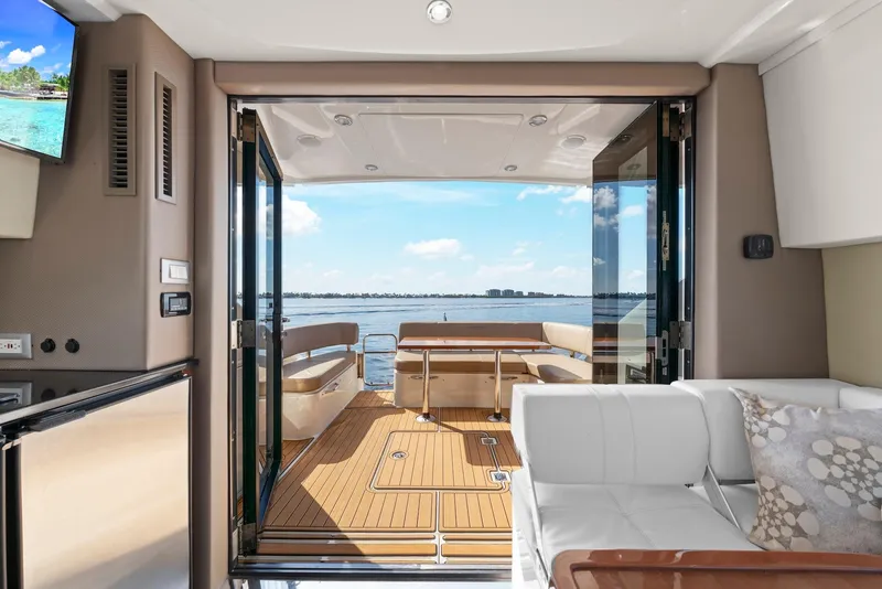 Slide: The Image of Interior view of 2016 Carver C37 Coupe yacht with open deck and waterfront scenery. - 31
