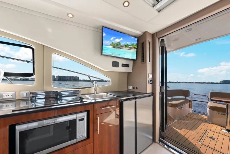 Slide: The Image of Interior of 2016 Carver C37 Coupe yacht with modern kitchen and scenic water view. - 36