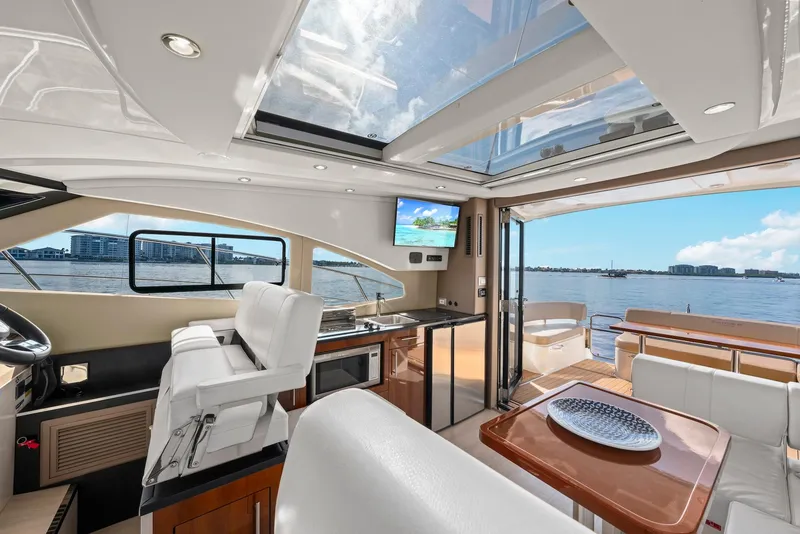 Slide: The Image of Interior of 2016 Carver C37 Coupe yacht with luxurious seating and panoramic water views. - 37